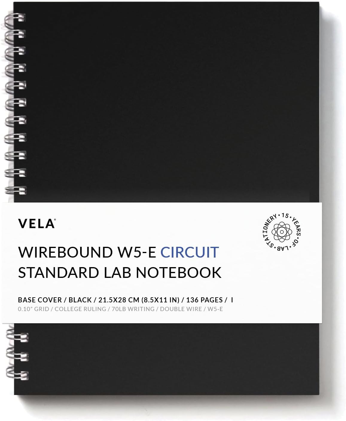 Vela Sciences Precision Grid Notebook 1-Pack on a lab bench with beakers and a laptop